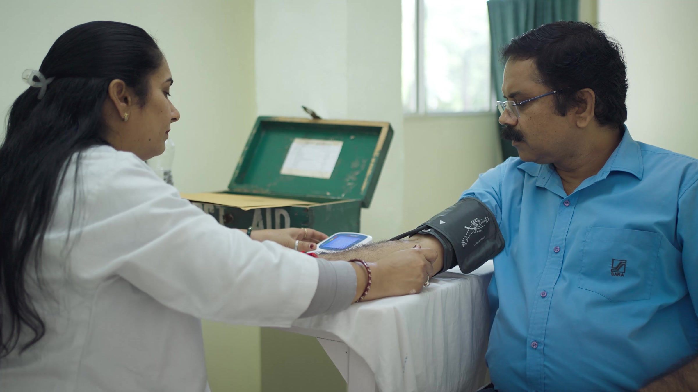 A health check at the plant, an employee's blood pressure being taken.