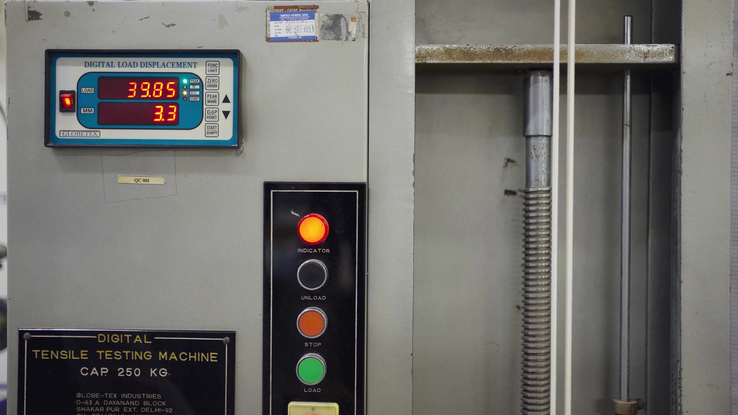 The digital tensile tester, 250 kg capacity, with its load reading lit.