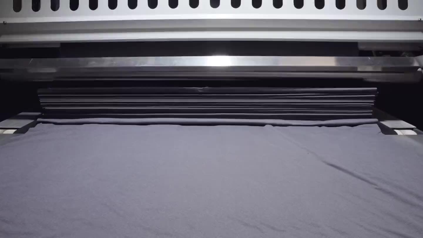 Knitted cloth coming off the machine as it is formed.