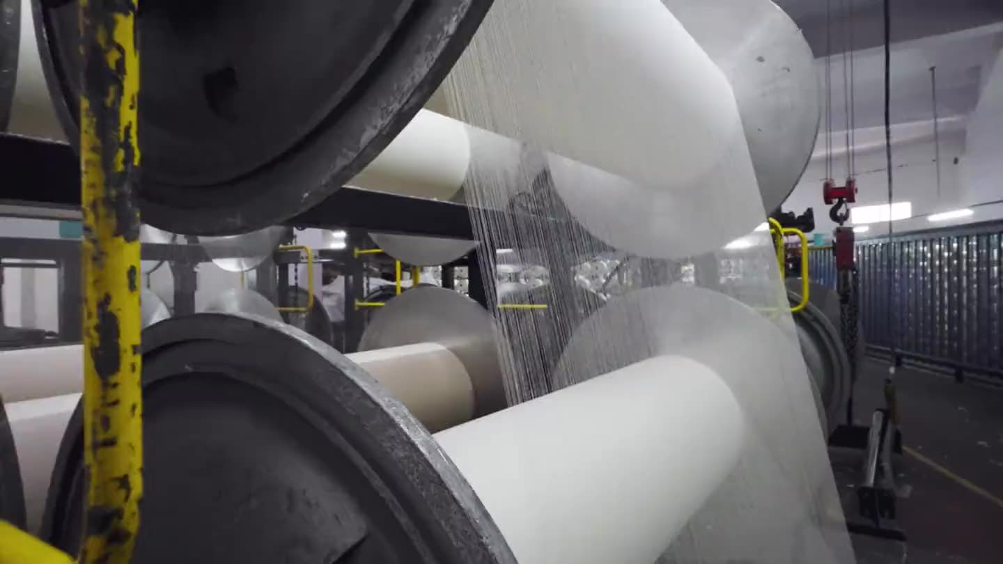 The warp sheet running through the sizing range and over the drying cylinders.