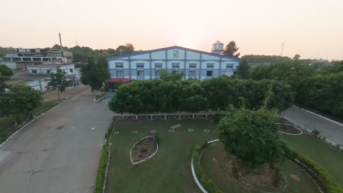 The plant from the air at sunset, then the electric fleet in the forecourt and a car on charge.